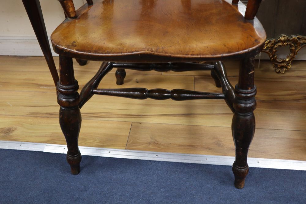 A Victorian ash and elm smokers bow armchair